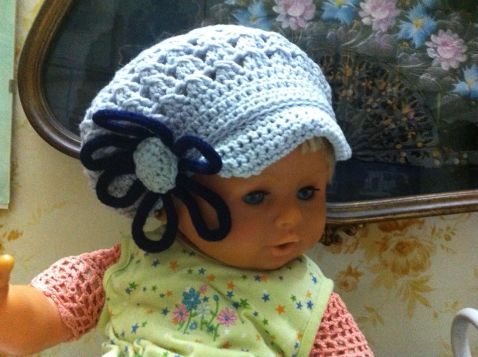 Cappello con visiera bicolore  all'uncinetto con fiore