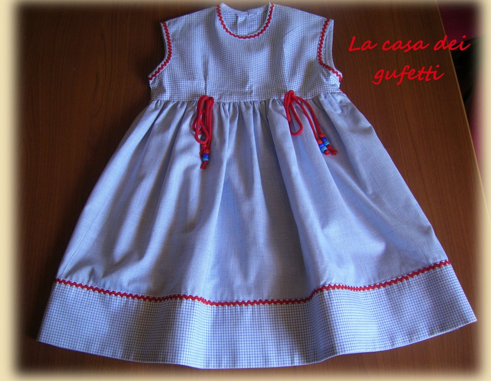 Vestitino a quadretti blu e bianchi con inserti in rosso e cordoni con perline in vita